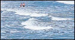 Swimmers enjoy the Myrtle Beach surf during a summer afternoon